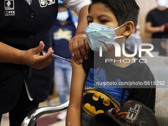 A child receives the first dose of Pfizer's during the pediatric vaccination campaign for children under 8 years of age   against Covid19 at...