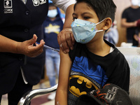 A child receives the first dose of Pfizer's during the pediatric vaccination campaign for children under 8 years of age   against Covid19 at...