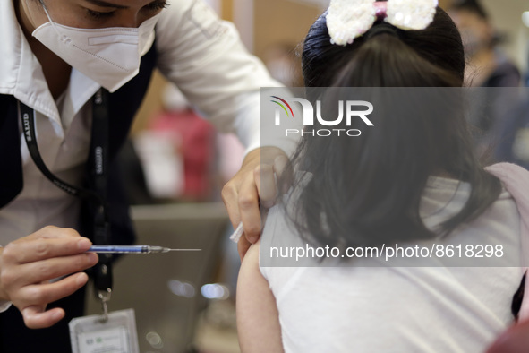 A child receives the first dose of Pfizer's during the pediatric vaccination campaign for children under 8 years of age   against Covid19 at...