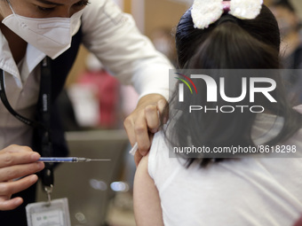 A child receives the first dose of Pfizer's during the pediatric vaccination campaign for children under 8 years of age   against Covid19 at...