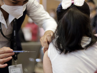 A child receives the first dose of Pfizer's during the pediatric vaccination campaign for children under 8 years of age   against Covid19 at...