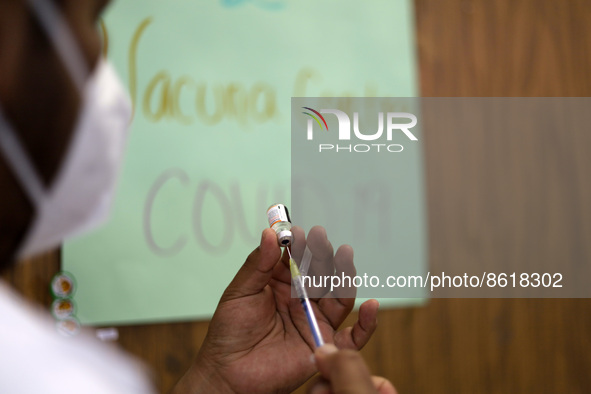 A health worker prepares a dose of Pfizer during the pediatric vaccination campaign for children under 8 years of age   against Covid19 at t...