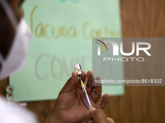 A health worker prepares a dose of Pfizer during the pediatric vaccination campaign for children under 8 years of age   against Covid19 at t...