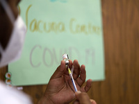 A health worker prepares a dose of Pfizer during the pediatric vaccination campaign for children under 8 years of age   against Covid19 at t...