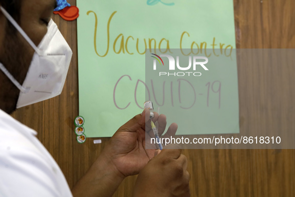 A health worker prepares a dose of Pfizer during the pediatric vaccination campaign for children under 8 years of age   against Covid19 at t...