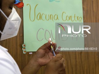 A health worker prepares a dose of Pfizer during the pediatric vaccination campaign for children under 8 years of age   against Covid19 at t...