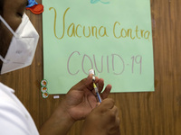 A health worker prepares a dose of Pfizer during the pediatric vaccination campaign for children under 8 years of age   against Covid19 at t...