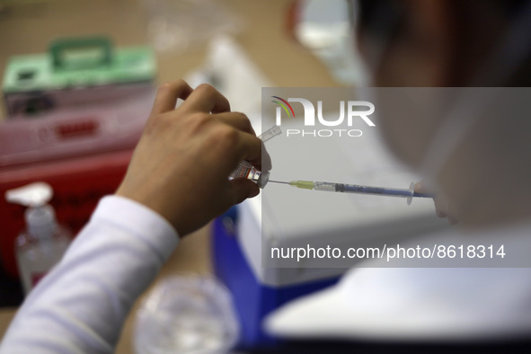 A health worker prepares a dose of Pfizer during the pediatric vaccination campaign for children under 8 years of age   against Covid19 at t...