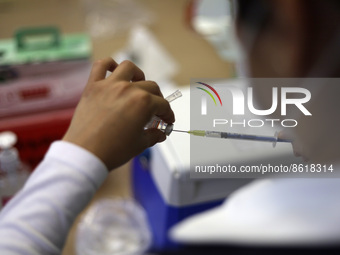 A health worker prepares a dose of Pfizer during the pediatric vaccination campaign for children under 8 years of age   against Covid19 at t...