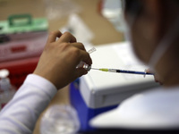 A health worker prepares a dose of Pfizer during the pediatric vaccination campaign for children under 8 years of age   against Covid19 at t...