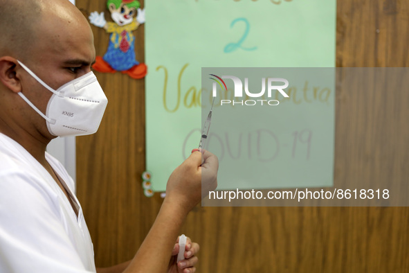 A health worker prepares a dose of Pfizer during the pediatric vaccination campaign for children under 8 years of age   against Covid19 at t...