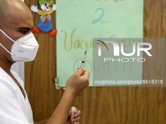 A health worker prepares a dose of Pfizer during the pediatric vaccination campaign for children under 8 years of age   against Covid19 at t...