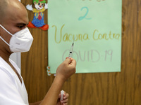 A health worker prepares a dose of Pfizer during the pediatric vaccination campaign for children under 8 years of age   against Covid19 at t...