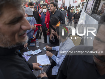 An Iranian health personnel checks documents of a man who wants to receive a dose of the Iranian Noora new coronavirus disease (COVID-19) va...