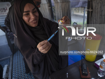 An Iranian female health personnel loads a syringe with the Iranian Noora new coronavirus disease (COVID-19) vaccine at a mobile vaccination...