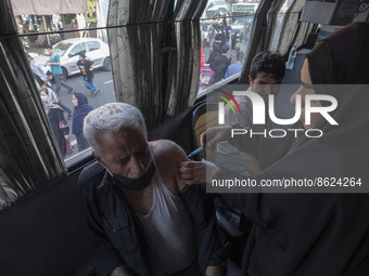 An Iranian man receives a dose of the Iranian Noora new coronavirus disease (COVID-19) vaccine at a mobile vaccination station during a cere...