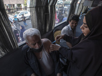 An Iranian man receives a dose of the Iranian Noora new coronavirus disease (COVID-19) vaccine at a mobile vaccination station during a cere...