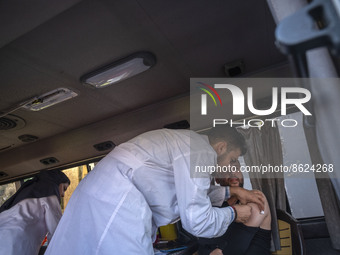 An Iranian man receives a dose of the Iranian Noora new coronavirus disease (COVID-19) vaccine at a mobile vaccination station during a cere...