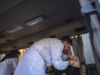 An Iranian man receives a dose of the Iranian Noora new coronavirus disease (COVID-19) vaccine at a mobile vaccination station during a cere...