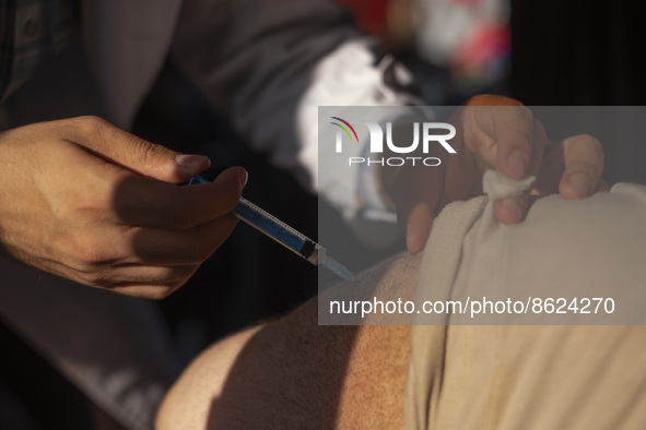 An Iranian man receives a dose of the Iranian Noora new coronavirus disease (COVID-19) vaccine at a mobile vaccination station during a cere...