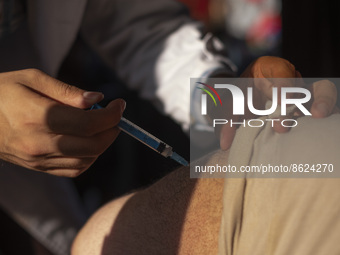 An Iranian man receives a dose of the Iranian Noora new coronavirus disease (COVID-19) vaccine at a mobile vaccination station during a cere...