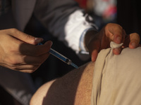 An Iranian man receives a dose of the Iranian Noora new coronavirus disease (COVID-19) vaccine at a mobile vaccination station during a cere...