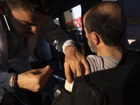 An Iranian man receives a dose of the Iranian Noora new coronavirus disease (COVID-19) vaccine at a mobile vaccination station during a cere...