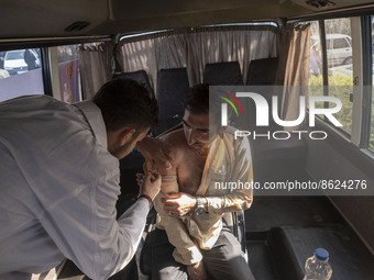 An Iranian man receives a dose of the Iranian Noora new coronavirus disease (COVID-19) vaccine at a mobile vaccination station during a cere...