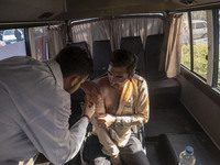 An Iranian man receives a dose of the Iranian Noora new coronavirus disease (COVID-19) vaccine at a mobile vaccination station during a cere...