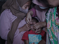 
A crying baby is immunized by a medical officer, during the BIAS (National Child Immunization Month) program at  Integrated Healthcare Cen...