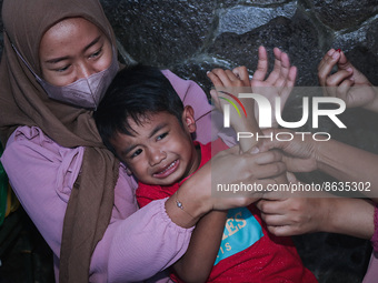 
A crying baby is immunized by a medical officer, during the BIAS (National Child Immunization Month) program at  Integrated Healthcare Cen...