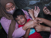 
A crying baby is immunized by a medical officer, during the BIAS (National Child Immunization Month) program at  Integrated Healthcare Cen...