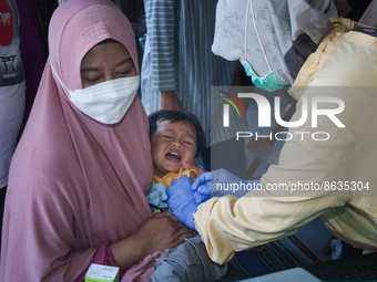 
A crying baby is immunized by a medical officer, during the BIAS (National Child Immunization Month) program at  Integrated Healthcare Cen...