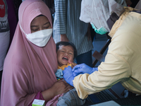 
A crying baby is immunized by a medical officer, during the BIAS (National Child Immunization Month) program at  Integrated Healthcare Cen...