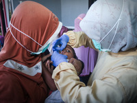 
A crying baby is immunized by a medical officer, during the BIAS (National Child Immunization Month) program at  Integrated Healthcare Cen...