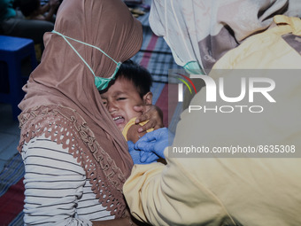 
A crying baby is immunized by a medical officer, during the BIAS (National Child Immunization Month) program at  Integrated Healthcare Cen...