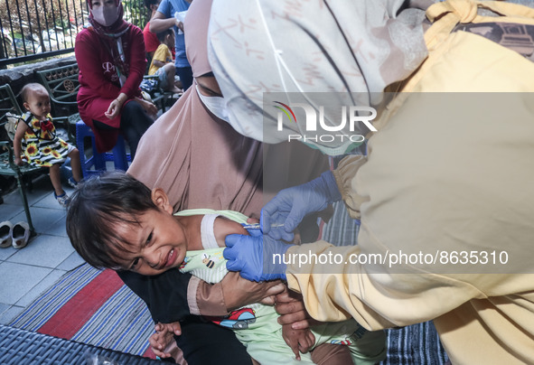 
A crying baby is immunized by a medical officer, during the BIAS (National Child Immunization Month) program at  Integrated Healthcare Cen...