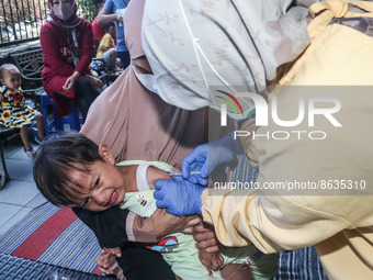 
A crying baby is immunized by a medical officer, during the BIAS (National Child Immunization Month) program at  Integrated Healthcare Cen...