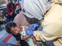 
A crying baby is immunized by a medical officer, during the BIAS (National Child Immunization Month) program at  Integrated Healthcare Cen...