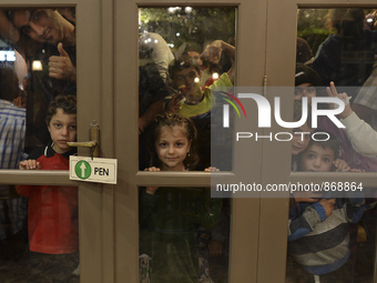 Refugees awaiting to enter to the Aspa Boomerang Restaurant, as the owner Michael Pastrikos, helped by his family members, his staff and man...