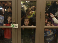 Refugees awaiting to enter to the Aspa Boomerang Restaurant, as the owner Michael Pastrikos, helped by his family members, his staff and man...