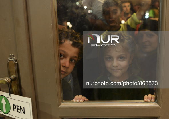 Children-refugees awaiting to enter to the Aspa Boomerang Restaurant, as the owner Michael Pastrikos, helped by his family members, his staf...