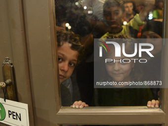 Children-refugees awaiting to enter to the Aspa Boomerang Restaurant, as the owner Michael Pastrikos, helped by his family members, his staf...