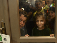 Children-refugees awaiting to enter to the Aspa Boomerang Restaurant, as the owner Michael Pastrikos, helped by his family members, his staf...