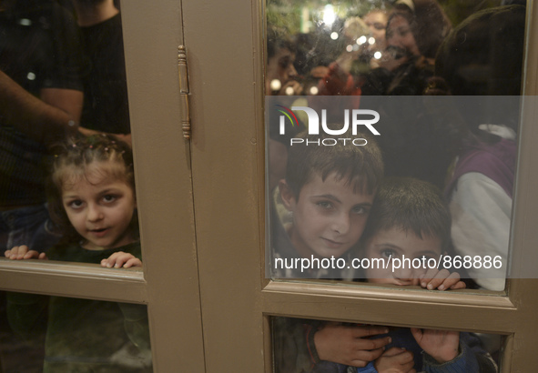 Children-refugees awaiting to enter to the Aspa Boomerang Restaurant, as the owner Michael Pastrikos, helped by his family members, his staf...