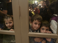 Children-refugees awaiting to enter to the Aspa Boomerang Restaurant, as the owner Michael Pastrikos, helped by his family members, his staf...