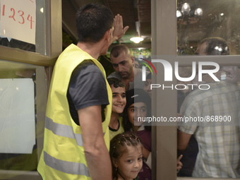 Happy children-refugees on their way to enter to the Aspa Boomerang Restaurant, as the owner Michael Pastrikos, helped by his family members...