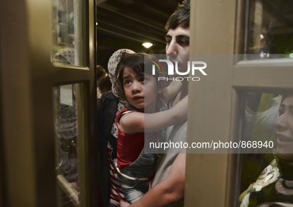 Families of refugees awaiting to enter to the Aspa Boomerang Restaurant, as the owner Michael Pastrikos, helped by his family members, his s...