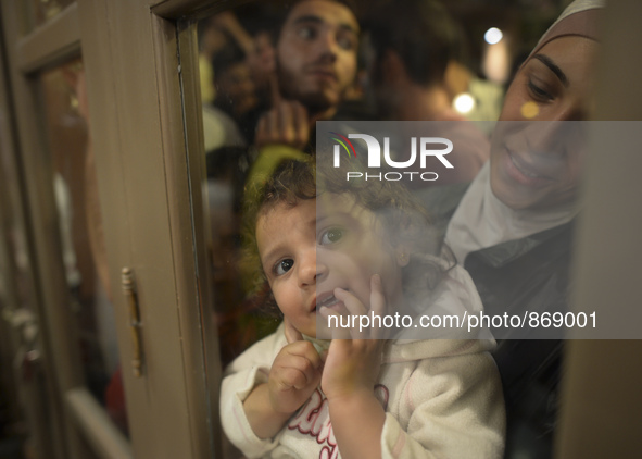 A young girl is looking trough the door as her family is awaiting to enter to the Aspa Boomerang Restaurant, as the owner Michael Pastrikos,...