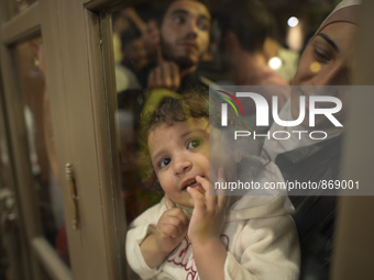 A young girl is looking trough the door as her family is awaiting to enter to the Aspa Boomerang Restaurant, as the owner Michael Pastrikos,...